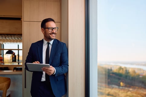 smiling man in suit working from home